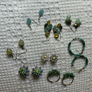 8 sets of earrings (costume jewelry). All either blue, teal or green.